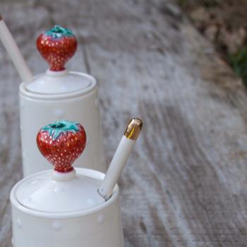 Tall strawberry jam pot with spoon